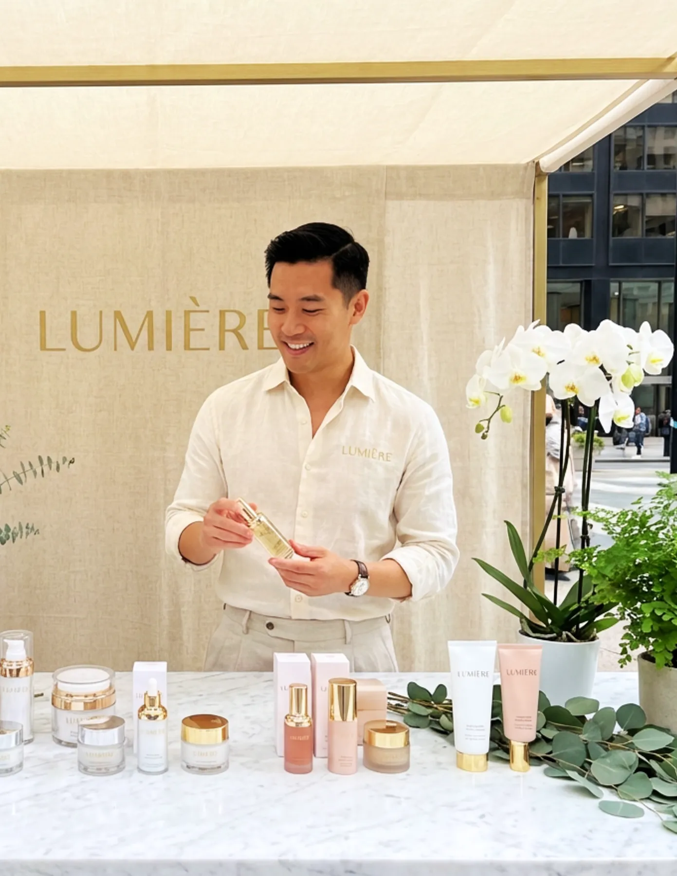 brand-ambassador-lumiere-skincare-product-activation-event-hmg-plus. Brand ambassador standing behind a display table at a Lumiere outdoor pop-up kiosk